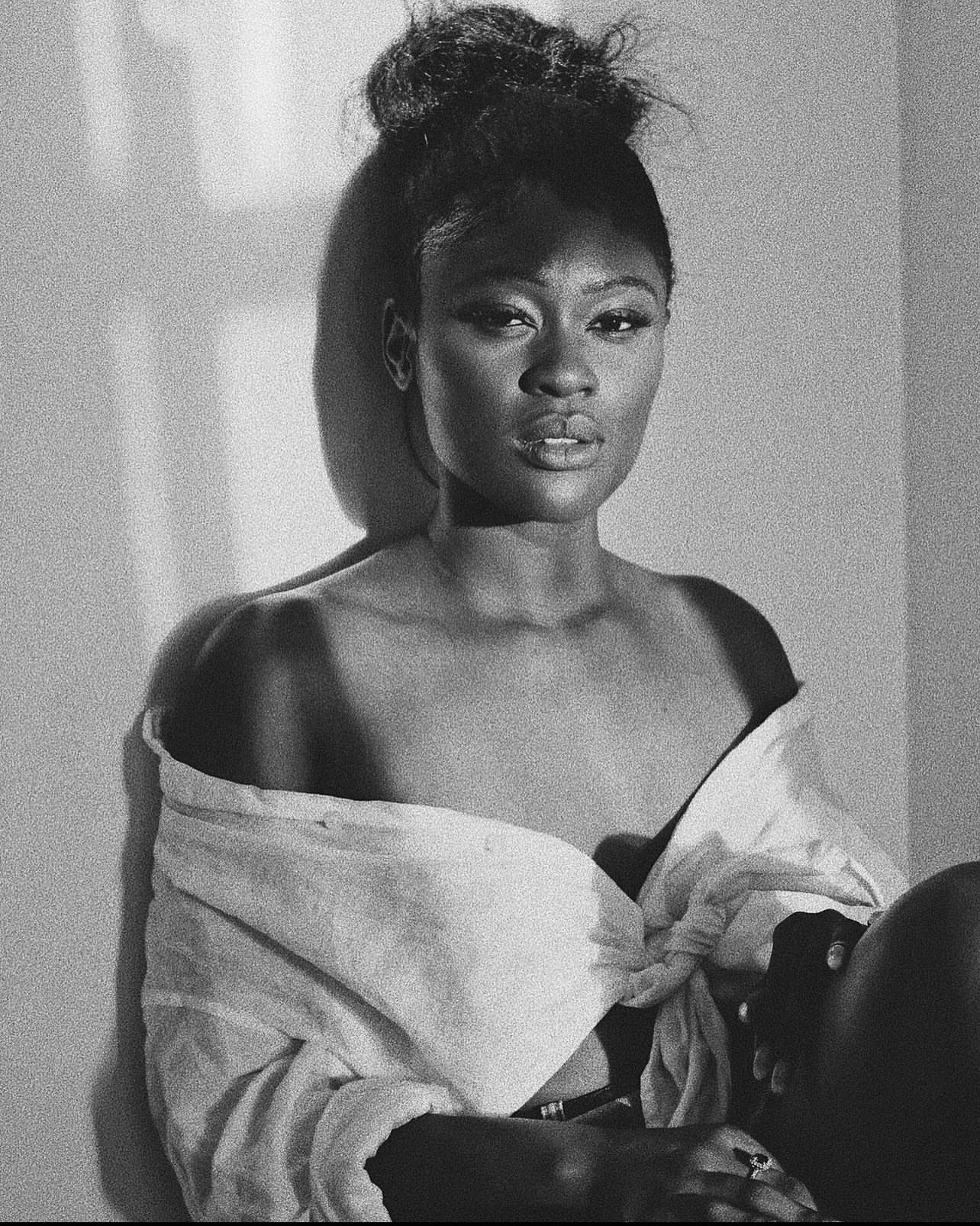 Black-and-white portrait of Adjoa Brown seated and looking toward the camera