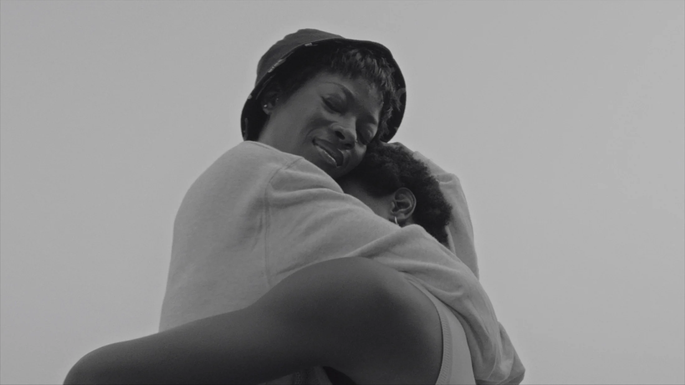 Two people embracing in an emotional black-and-white frame